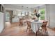 Open kitchen and dining area with white cabinets, an island, and modern pendant lighting at 1000 Oakshade Ave, Kannapolis, NC 28083