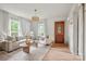 Bright living room with a decorative chandelier, wood front door, and comfortable seating arrangement at 1000 Oakshade Ave, Kannapolis, NC 28083