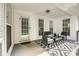 Charming covered back porch with ample seating and stylish outdoor rug at 1140 Landsdown Dr, Salisbury, NC 28147