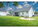 A well-maintained backyard has a grassy lawn, a patio with chairs and a covered porch area at 1140 Landsdown Dr, Salisbury, NC 28147