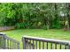 Lush, green backyard with wooden fence and mature trees for privacy at 1140 Landsdown Dr, Salisbury, NC 28147