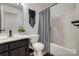 A stylish bathroom featuring a vanity, a toilet and a shower/tub with a modern black and white patterned shower curtain at 1140 Landsdown Dr, Salisbury, NC 28147