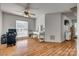Spacious bedroom with wood floors features a ceiling fan, vanity, and large windows at 1140 Landsdown Dr, Salisbury, NC 28147