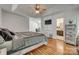 A bright, modern bedroom features hardwood floors, tray ceiling, and a view into an office and the attached bathroom at 1140 Landsdown Dr, Salisbury, NC 28147