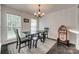 Dining room features a wood table and bench and chandelier at 1140 Landsdown Dr, Salisbury, NC 28147