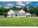 Charming white house features a well-manicured lawn and a detached two-car garage at 1140 Landsdown Dr, Salisbury, NC 28147