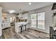 Lovely kitchen with wooden floors, modern white cabinets, stainless appliances, and breakfast bar at 1140 Landsdown Dr, Salisbury, NC 28147