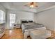 The main bedroom features wood floors, recessed ceilings, bright windows, and modern rustic furniture at 1140 Landsdown Dr, Salisbury, NC 28147