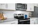 Modern kitchen featuring stainless steel appliances, white cabinets, granite counters, and a subway tile backsplash at 118 Parker Claire Ln, Kings Mountain, NC 28086