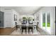 Open-concept living area featuring a dining table, white walls, hardwood floors, and modern decor at 118 Parker Claire Ln, Kings Mountain, NC 28086