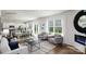 Open-concept living room with hardwood flooring, neutral furniture, and sliding glass doors to the backyard at 118 Parker Claire Ln, Kings Mountain, NC 28086