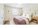 A cozy bedroom features a queen bed, neutral colors, and bright natural light from the window at 1215 Green Oaks Ln # H, Charlotte, NC 28205
