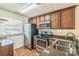 Well-equipped kitchen featuring stainless steel appliances, wooden cabinets, and granite countertops at 1215 Green Oaks Ln # H, Charlotte, NC 28205