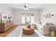Bright living room features hardwood floors, a ceiling fan, and access to the backyard at 1215 Green Oaks Ln # H, Charlotte, NC 28205