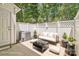 The staged patio offers outdoor seating with a white privacy fence and lush trees at 1215 Green Oaks Ln # H, Charlotte, NC 28205