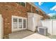 A patio with red brick and double glass doors leading to an outdoor space at 1215 Green Oaks Ln # H, Charlotte, NC 28205