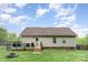 The backyard offers an ideal outdoor space with a deck, patio, and well-maintained landscaping at 1221 Woodpecker Dr, Clover, SC 29710
