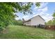 A sprawling backyard with a deck and landscaped surroundings ensures privacy and relaxation at 1221 Woodpecker Dr, Clover, SC 29710