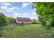 Large backyard with green grass, shed, and deck at 1221 Woodpecker Dr, Clover, SC 29710
