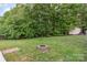 The backyard has lush greenery, a shed, and ample space for relaxation and recreational activities at 1221 Woodpecker Dr, Clover, SC 29710