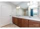 Bathroom featuring double sinks, wood cabinets, and a large mirror at 1221 Woodpecker Dr, Clover, SC 29710