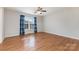 Sunlit bedroom featuring hardwood floors, a window, and a ceiling fan, creating a serene atmosphere at 1221 Woodpecker Dr, Clover, SC 29710