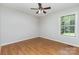 Bright, inviting bedroom with hardwood floors, a ceiling fan, and large window offering natural light and views at 1221 Woodpecker Dr, Clover, SC 29710