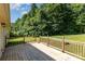 Spacious wooden deck overlooking a lush green yard with mature trees, ideal for outdoor entertaining and relaxation at 1221 Woodpecker Dr, Clover, SC 29710
