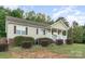 Inviting exterior view with landscaped shrubs and cozy front porch at 1221 Woodpecker Dr, Clover, SC 29710