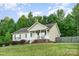 A well-manicured lawn complements this inviting home with a covered front porch at 1221 Woodpecker Dr, Clover, SC 29710