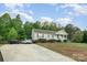 A serene home featuring a long driveway and lush green surroundings at 1221 Woodpecker Dr, Clover, SC 29710