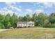 A quaint single-Gathering home set back on a spacious, grassy lot at 1221 Woodpecker Dr, Clover, SC 29710