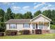 Charming single-story home featuring a covered front porch and well-maintained landscaping at 1221 Woodpecker Dr, Clover, SC 29710