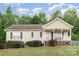 Charming single-story home with a welcoming front porch and well-maintained landscaping at 1221 Woodpecker Dr, Clover, SC 29710