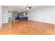 Open-concept living space flowing into the kitchen, featuring hardwood floors and neutral walls at 1221 Woodpecker Dr, Clover, SC 29710