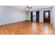 Spacious living room featuring gleaming hardwood floors, large window, and a decorative front door at 1221 Woodpecker Dr, Clover, SC 29710