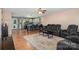Open floor plan with dark leather furniture connecting the living room and kitchen at 1221 Woodpecker Dr, Clover, SC 29710