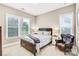 Cozy bedroom with a queen-sized bed, side tables, and natural light from two windows at 13204 Feale Ct, Charlotte, NC 28278