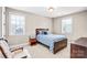 Bedroom with natural light, a dark wood bed frame, and reading chair at 13204 Feale Ct, Charlotte, NC 28278