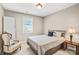 Bedroom with a metal bed frame, bedside table, and reading chair at 13204 Feale Ct, Charlotte, NC 28278