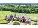 Aerial view of clubhouse with golf course in background and beautiful landscaping in the foreground at 13204 Feale Ct, Charlotte, NC 28278