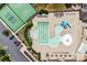Aerial shot displaying community pool with a slide, tennis courts, lounge chairs, and manicured grounds, offering recreational amenities at 13204 Feale Ct, Charlotte, NC 28278