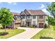 Well-maintained two-story home featuring mixed siding and a spacious front yard with a long driveway at 13204 Feale Ct, Charlotte, NC 28278