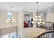 Grand foyer featuring high ceilings, two chandeliers, and a staircase with wrought iron railings at 13204 Feale Ct, Charlotte, NC 28278
