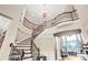 Elegant foyer showcases curved staircase, high ceiling and decorative lighting fixture at 13204 Feale Ct, Charlotte, NC 28278