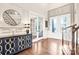 A stunning foyer with gleaming hardwood floors, a stylish sideboard, and French doors at 13204 Feale Ct, Charlotte, NC 28278