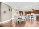 Open-concept kitchen and dining area features modern lighting and beautiful hardwood floors at 13204 Feale Ct, Charlotte, NC 28278