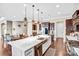 Spacious kitchen island with stainless steel sink and dishwasher with dining area in the background at 13204 Feale Ct, Charlotte, NC 28278
