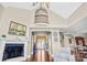 Open-concept living room with a fireplace, hardwood floors, and access to the dining area at 13204 Feale Ct, Charlotte, NC 28278
