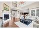 Open-concept living room with a fireplace, hardwood floors, and large windows at 13204 Feale Ct, Charlotte, NC 28278